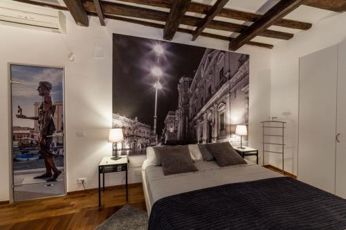 Postel nebo postele na pokoji v ubytování Cassandra Charme Apartment by Ortigiaapartments