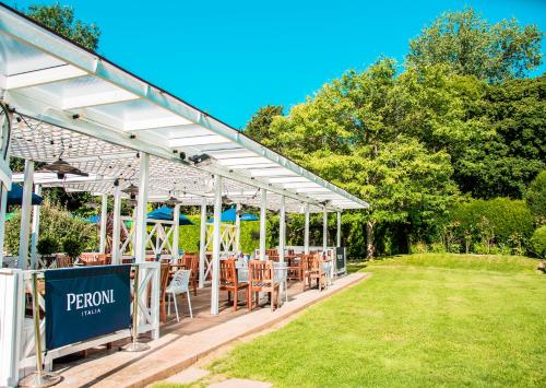 a pavilion with tables and chairs in a park at The Old Mill in Lymington
