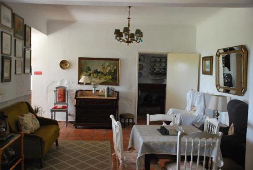 a living room with a table and a couch at Monte Ramos in Ferreira do Alentejo