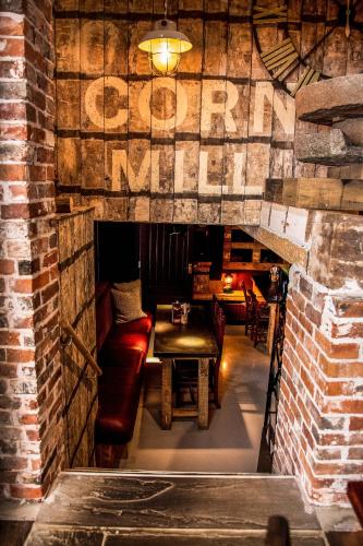 a room with a couch and a table and a brick wall at The Old Mill in Lymington