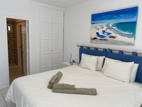 a bedroom with a bed with a towel on it at Casa Louise in Costa Teguise