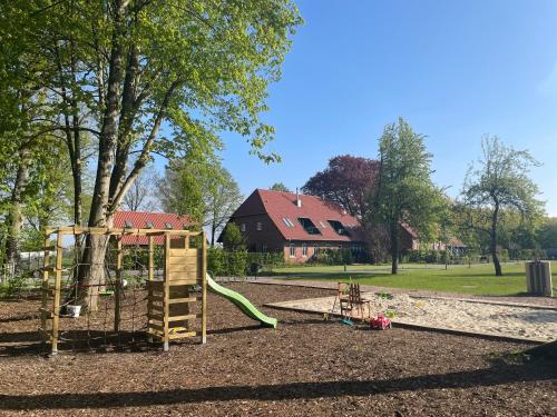 a park with a playground with a slide at Meine Schule Sehlingen, Familien-Apartment mit Sauna & Spielplatz! in Kirchlinteln