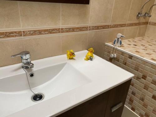 a bathroom sink with three rubber ducks sitting on it at Casa Louise in Costa Teguise