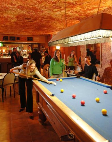 a group of people playing pool in a bar at Ali's Underground Home in Coober Pedy