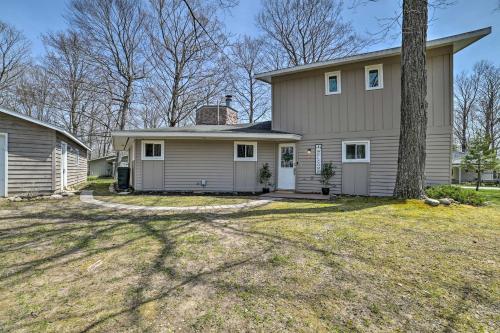 a house with a tree in the yard at Close to 3 Ski Areas Michigan Family Retreat! in Charlevoix