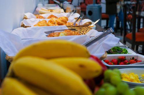 a buffet line of food with bananas and fruit at Hotel Kapac Inn-San Blas in Cusco
