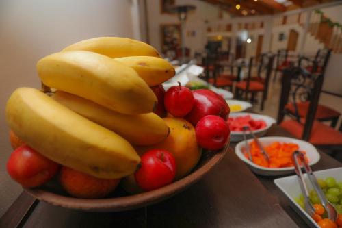 a bowl of bananas and other fruit on a table at Hotel Kapac Inn-San Blas in Cusco