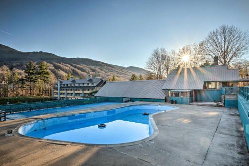 an empty swimming pool in front of a building at Loon Mountain Townhome with Pool and Slope Views! in Lincoln