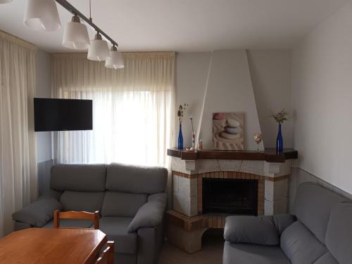 a living room with a couch and a fireplace at Casa Icaro in Barreiros
