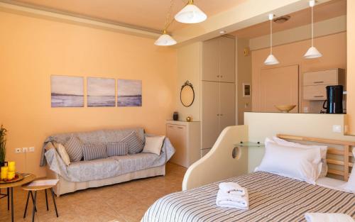 a living room with a bed and a couch at Sitia Old Port studio - 3min walk to beach - AC - WIFI in Sitia