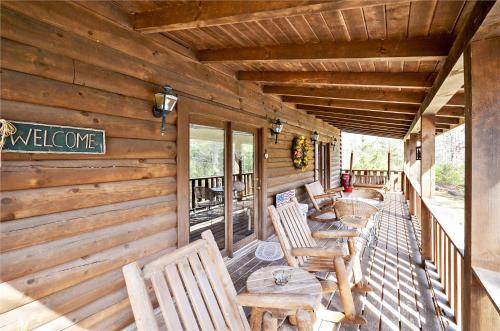 a porch of a cabin with wooden tables and chairs at Always and Forever in Pigeon Forge