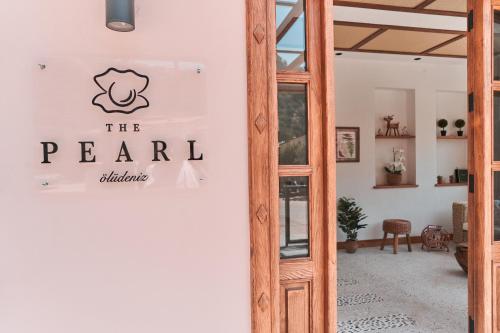 a sign for the pearl restaurant on the wall of a room at The Pearl Ölüdeniz in Oludeniz