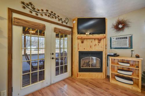 a living room with a fireplace and a flat screen tv at Sweetpeas in Pigeon Forge