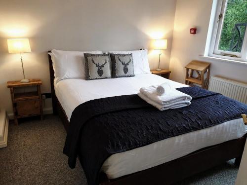a bedroom with a bed with towels on it at Lake View Country House in Grasmere