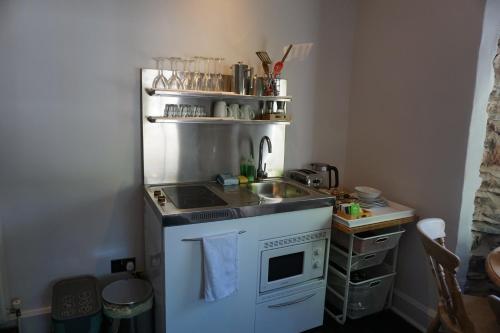 a small kitchen with a sink and a microwave at Lake View Country House in Grasmere