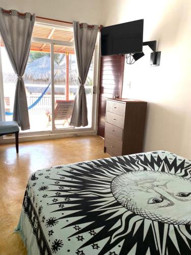 a bedroom with a zebra print bed with a window at Casa de las Olas Surf & Beach Club in Acapulco