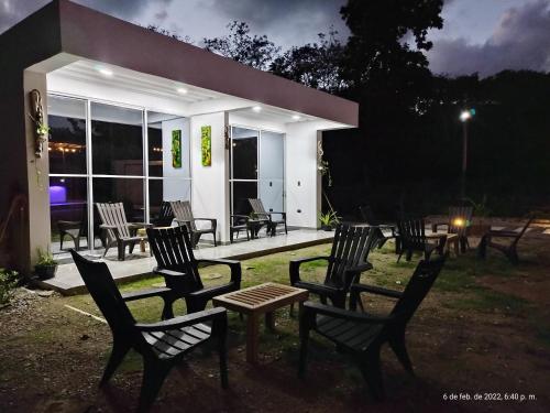 a group of chairs and tables in front of a building at Hotel Magic Capurganá in Capurganá