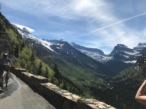 a person riding a bike on a mountain road at Good Medicine Lodge in Whitefish