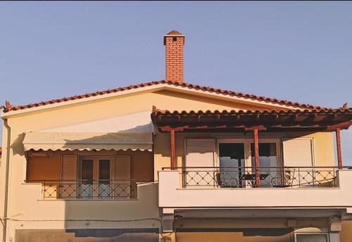 a house with a balcony and a chimney at Family Home Myrina Lemnos in Myrina