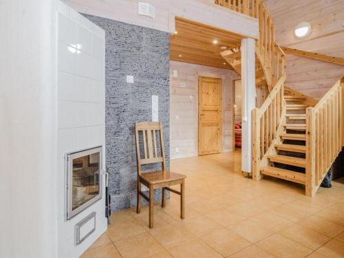 a room with a staircase and a chair and a fireplace at Holiday Home Amero purnu 5 in Kolinkylä