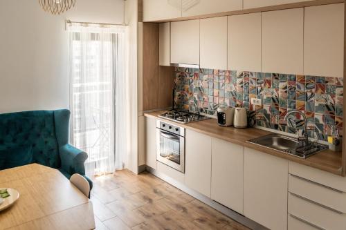 a kitchen with a sink and a stove at Cotroceni Smart Residence Studio in Bucharest