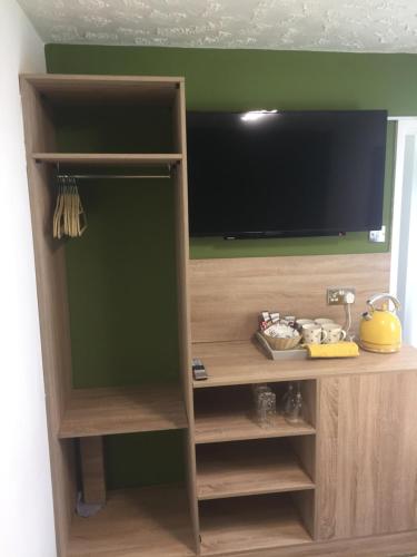 a entertainment center with a flat screen tv at Beaucliffe continental in Blackpool