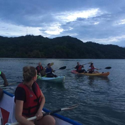 a group of people in kayaks on a lake at Donde Familia Manito in Paquera