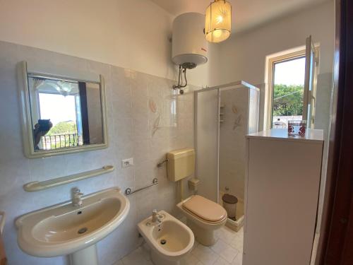 a bathroom with a sink and a toilet at Fiordaliso - Holiday Housing in Lipari