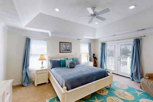 a bedroom with a bed and a ceiling fan at A Slice of Paradise in Virginia Beach