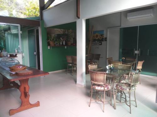 a dining room with a table and chairs on a patio at Pousada Ares do Sul in Penha