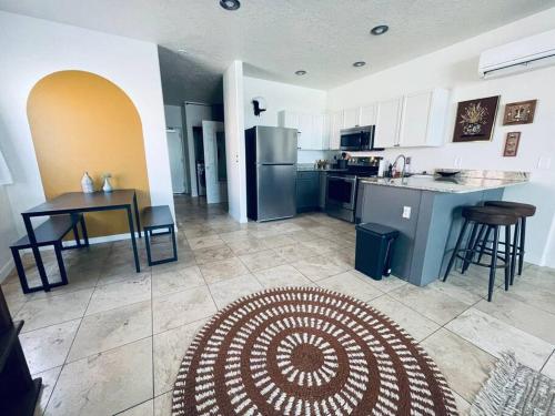 a kitchen with a table and a kitchen with a counter at Pet Friendly! Private retreat in Nob Hill in Albuquerque