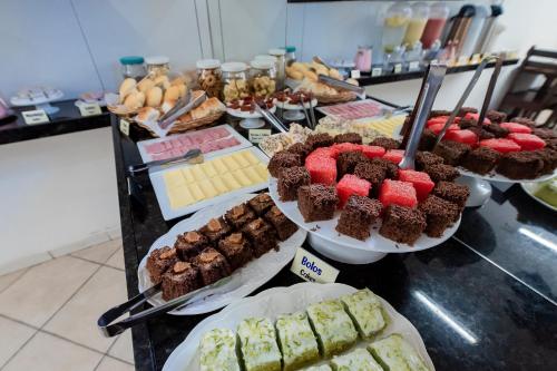 a buffet with many different types of desserts on display at Pousada Terra do Sol Natal in Natal