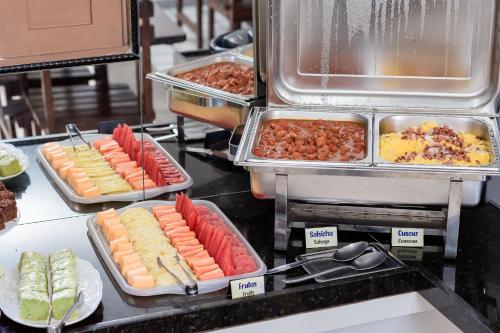a buffet line with many different types of food at Pousada Terra do Sol Natal in Natal
