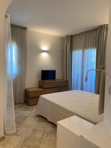 Giường trong phòng chung tại Residence Sherden, Appartamento Spiaggia Bianca