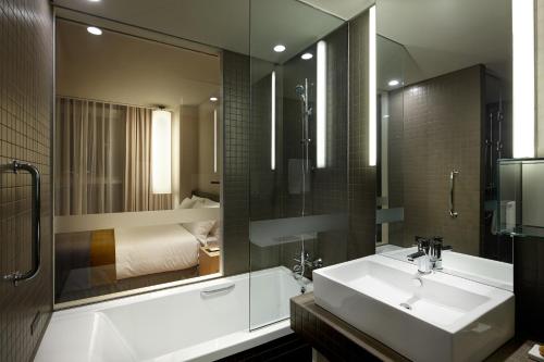 a bathroom with a sink and a large mirror at Shilla Stay Yeoksam in Seoul