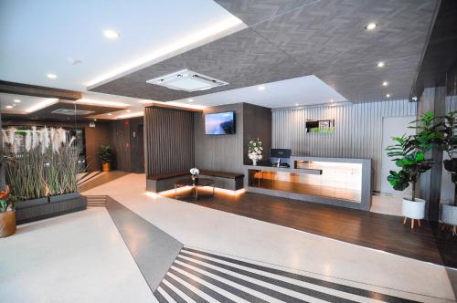 an office lobby with a dance floor and a tv at The S Block Condotel in Ban Si Than