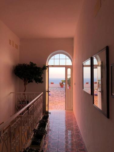 a hallway with a view of the ocean from a house at Hotel Villa Maria in Ischia