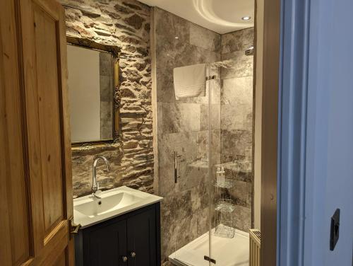 a bathroom with a sink and a glass shower at Lake View Country House in Grasmere