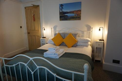 a bedroom with a bed with towels on it at Lake View Country House in Grasmere
