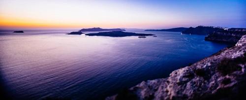 a view of a large body of water at sunset at Arcana Santorini Villas, An Authentic Cycladic Experience in Akrotiri