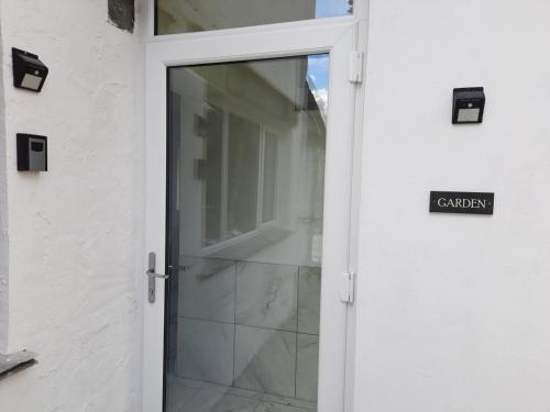 an open door with a sign that reads garden at Lake View Country House in Grasmere