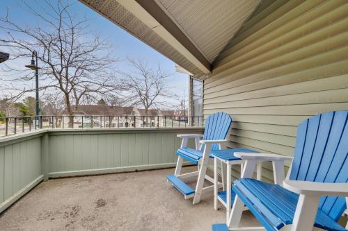 two blue and white chairs on a porch at 212 Pointes North Inn in Charlevoix