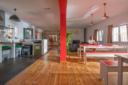 a man is standing in a large kitchen at Tarifa Kite Hostel in Tarifa