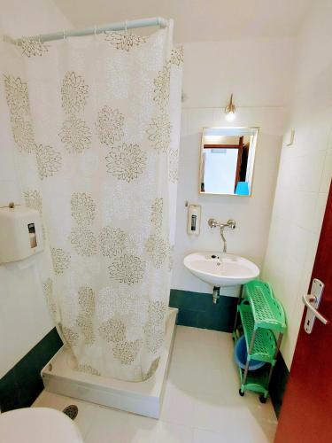 a bathroom with a shower curtain and a sink at Casa di Castello in Mali Lošinj