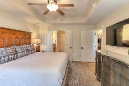 a bedroom with a bed and a flat screen tv at RiverStone Condo Resort & Spa in Pigeon Forge