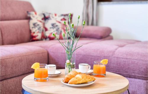 a coffee table with a plate of food and orange juice at Stunning Home In Pitomaca With Wifi in Pitomača