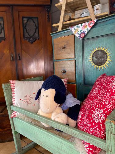 a stuffed teddy bear sitting on a bed at Karczma Kubalonka in Istebna
