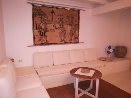 a living room with a white couch and a table at Sal Rei apartaments, Boa Vista, free WI-FI in Sal Rei