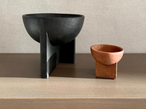 a black bowl and a pot sitting next to a wall at Agnadema Apartments in Firostefani
