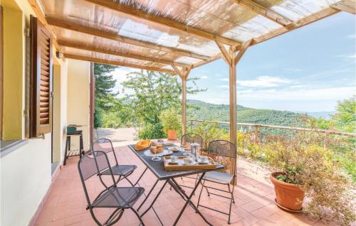 a table and chairs on a patio with a view at Casetta 2 in Loro Ciuffenna